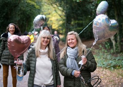 smiling with balloons on a walk
